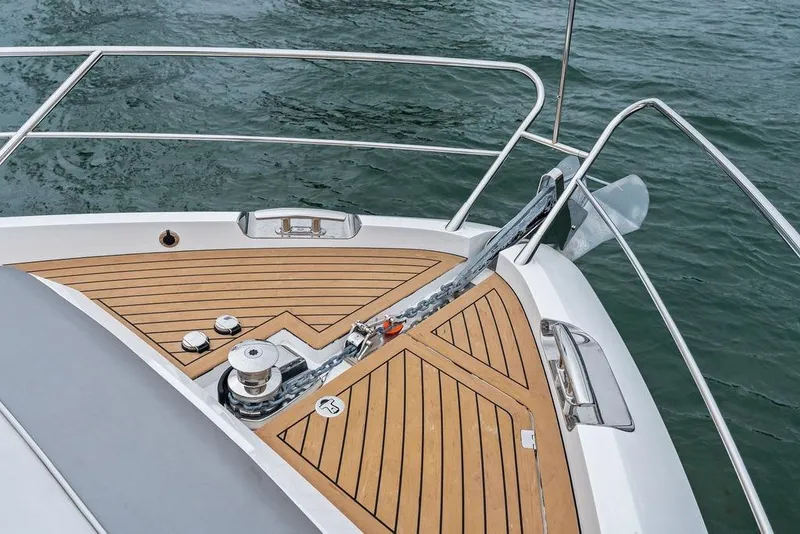 Slide: The Image of Bow of 2022 Sunseeker 65 Sport Yacht with teak decking and anchor chain. - 47