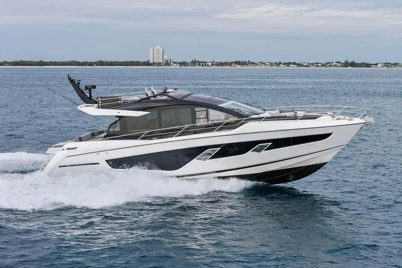 Slide: The Image of 2022 Sunseeker 65 Sport Yacht cruising on open water, showcasing sleek design and luxury. - 5
