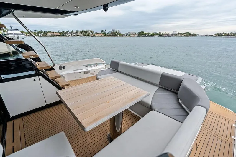 Slide: The Image of Luxurious 2022 Sunseeker 65 Sport Yacht deck with elegant seating and scenic water view. - 50