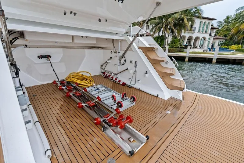 Slide: The Image of Sunseeker 65 Sport Yacht 2022, open deck with storage and equipment, dockside view. - 56