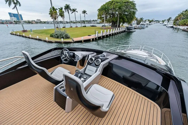 Slide: The Image of 2022 Sunseeker 65 Sport Yacht helm with sleek design, overlooking scenic waterfront. - 60