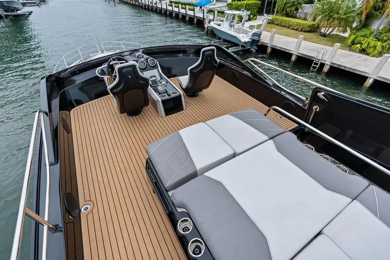 Slide: The Image of 2022 Sunseeker 65 Sport Yacht with sleek deck and luxurious seating, docked by the water. - 63