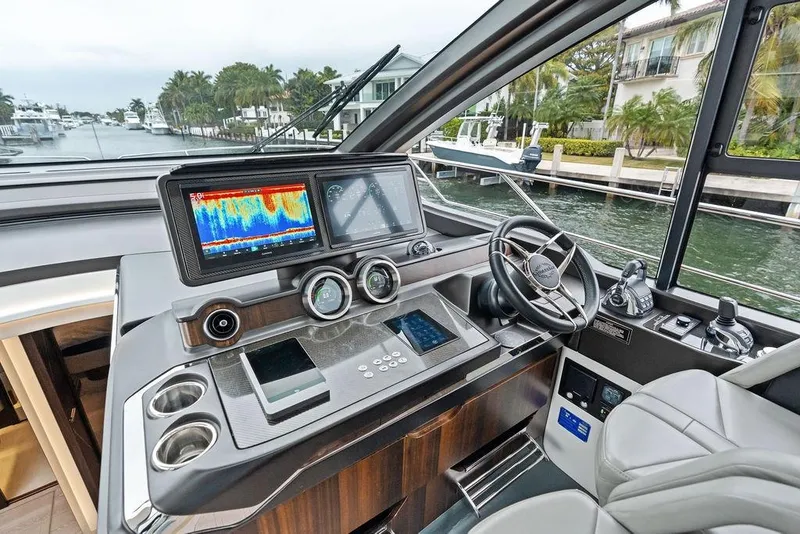 Slide: The Image of 2022 Sunseeker 65 Sport Yacht helm with advanced navigation displays and luxurious design. - 64