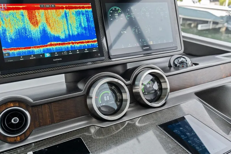 Slide: The Image of Dashboard of 2022 Sunseeker 65 Sport Yacht with advanced Garmin navigation displays. - 65