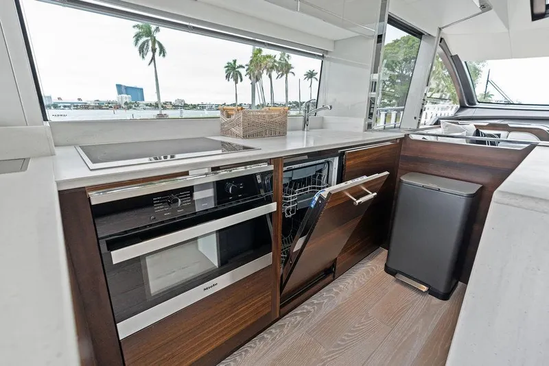 Slide: The Image of Modern kitchen interior of 2022 Sunseeker 65 Sport Yacht with appliances and scenic window view. - 70