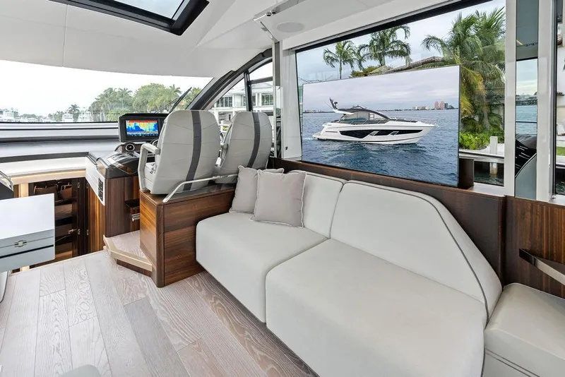 Slide: The Image of Luxurious interior of 2022 Sunseeker 65 Sport Yacht with modern seating and navigation area. - 76