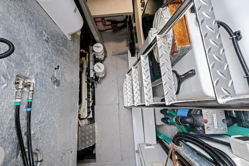Slide: The Image of Engine room of 2022 Sunseeker 65 Sport Yacht with visible machinery and ladder. - 78