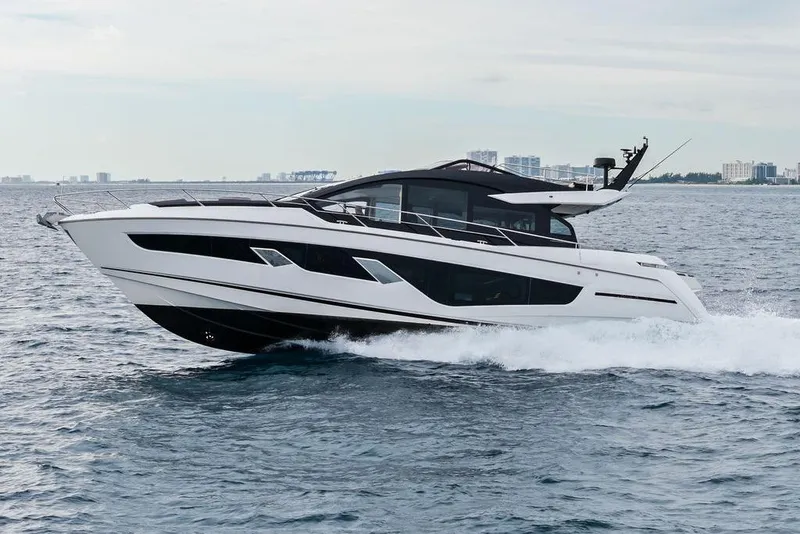Slide: The Image of 2022 Sunseeker 65 Sport Yacht cruising on open water, showcasing sleek design and luxury. - 8