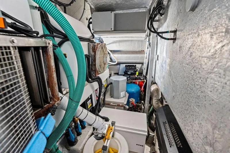 Slide: The Image of Engine room of 2022 Sunseeker 65 Sport Yacht with complex machinery and wiring. - 84