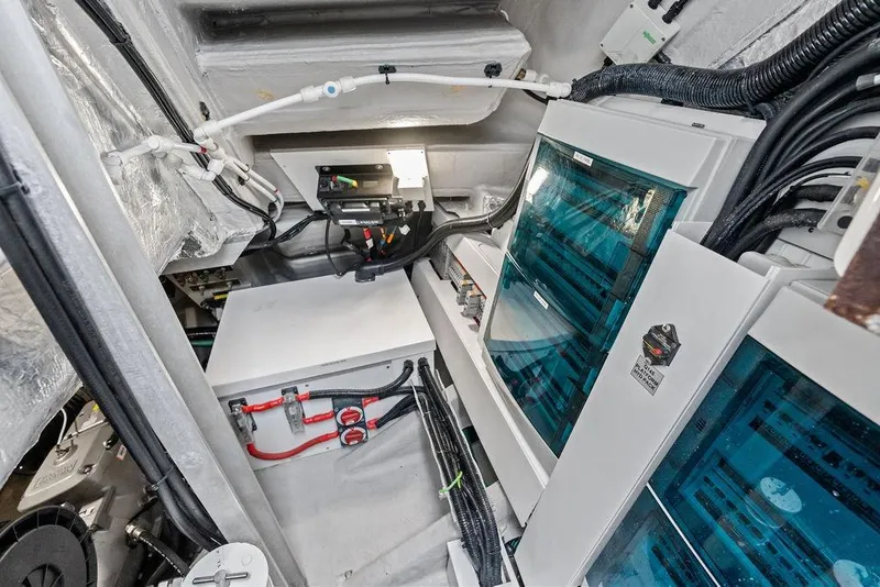 Slide: The Image of Engine room of 2022 Sunseeker 65 Sport Yacht, showcasing electrical systems and wiring. - 86