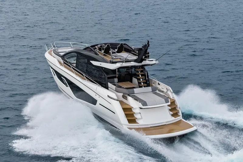 Slide: The Image of 2022 Sunseeker 65 Sport Yacht cruising on open water, showcasing sleek design and luxury. - 9