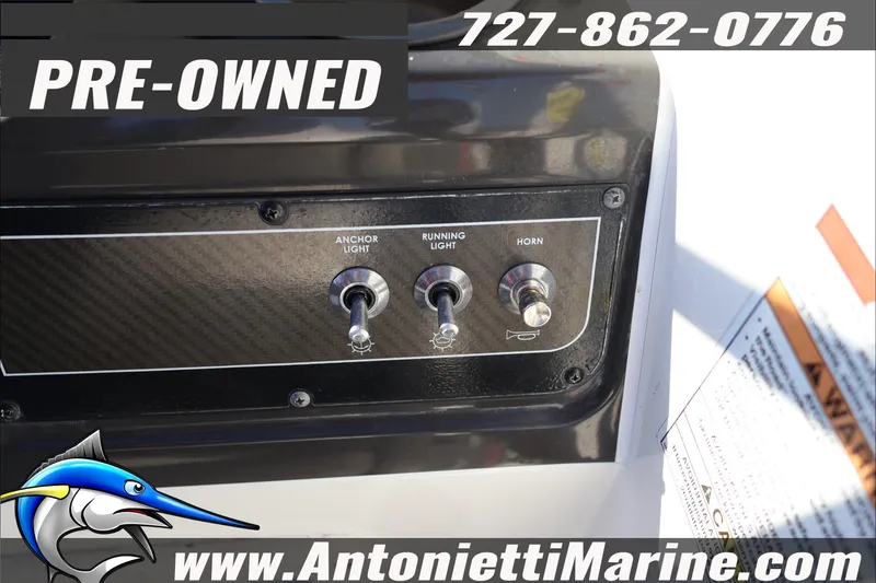 Slide: The Image of Pre-owned 2022 Bayliner VR4 Bowrider OB control panel with switches, contact info visible. - 20