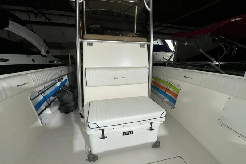 Slide: The Image of Interior of a 2006 Clearwater 2508 boat with white seating and Yeti cooler. - 11