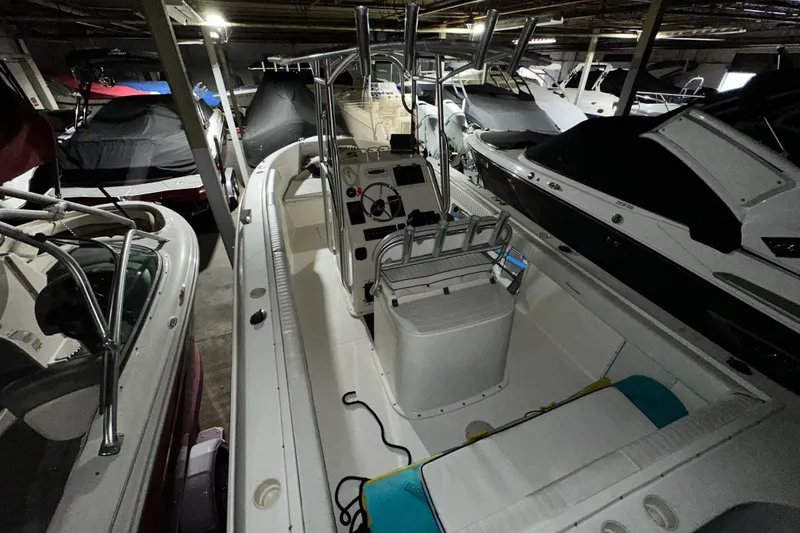 Slide: The Image of 2006 Clearwater 2508 boat in storage, surrounded by other covered boats. - 3