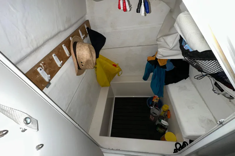 Slide: The Image of Interior storage area of a 2006 Clearwater 2508 boat with various items and hooks. - 9