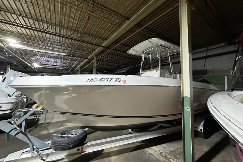 The Image of 2006 Clearwater 2508 boat on trailer in indoor storage facility. - 0