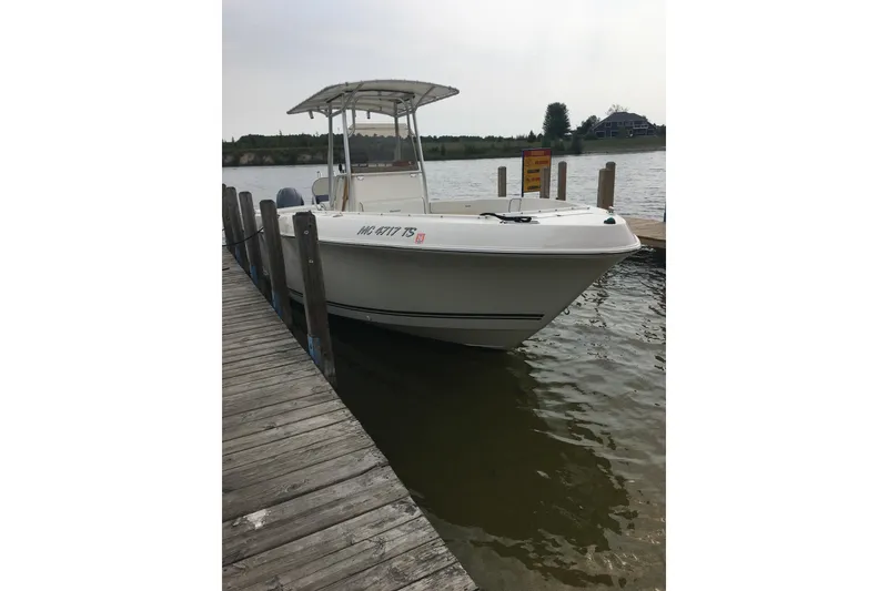 Slide: The Image of 2006 Clearwater 2508 boat docked on a calm lake. - 13
