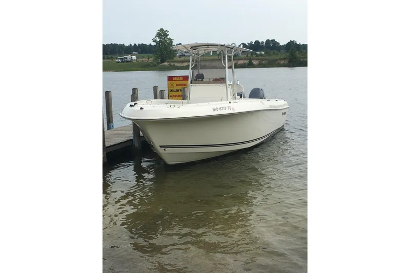 Slide: The Image of 2006 Clearwater 2508 boat docked on a calm lake. - 14