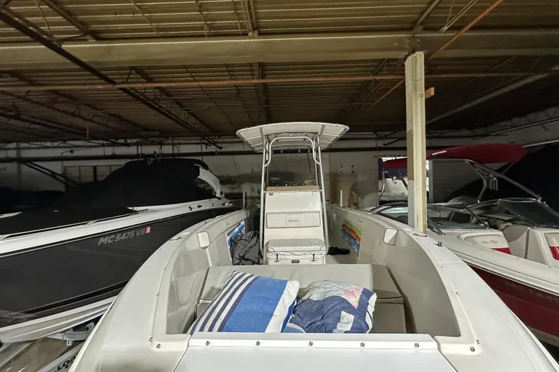 Slide: The Image of 2006 Clearwater 2508 boat stored indoors with other vessels. - 2