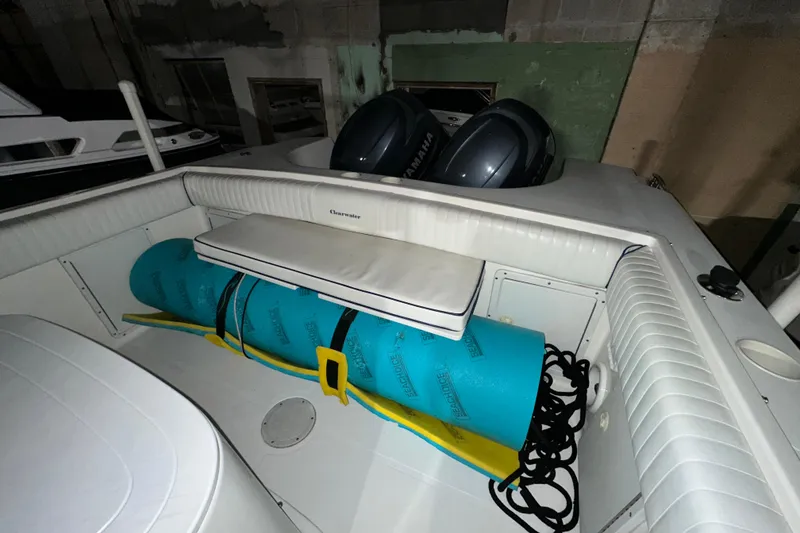 Slide: The Image of 2006 Clearwater 2508 boat interior with seating and storage, featuring dual Yamaha engines. - 4