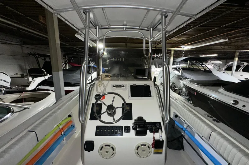 Slide: The Image of 2006 Clearwater 2508 boat interior with steering wheel and control panel in storage. - 6