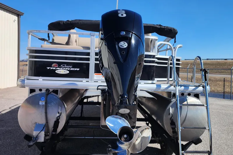 Slide: The Image of 2022 Sun Tracker Fishin' Barge 22 DLX pontoon boat with outboard motor and ladder. - 4