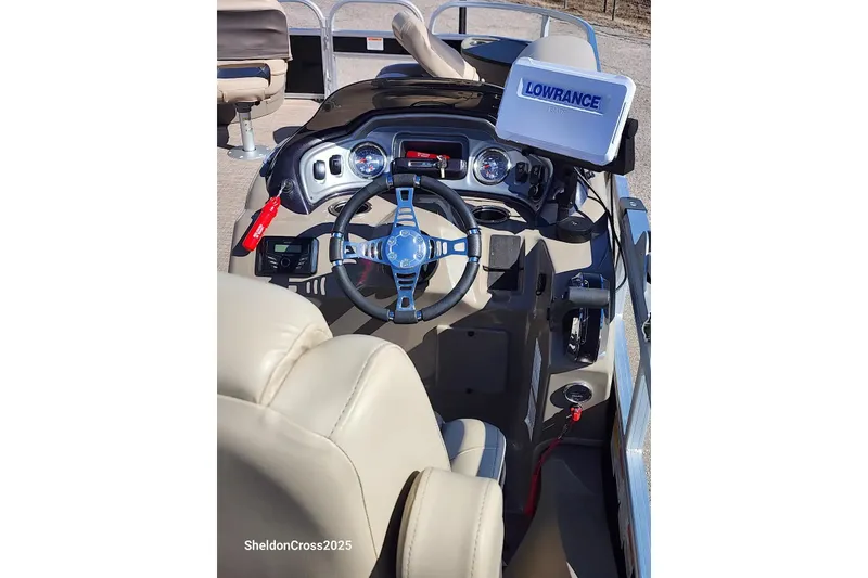 Slide: The Image of Interior view of 2022 Sun Tracker Fishin' Barge 22 DLX with steering wheel and Lowrance display. - 7