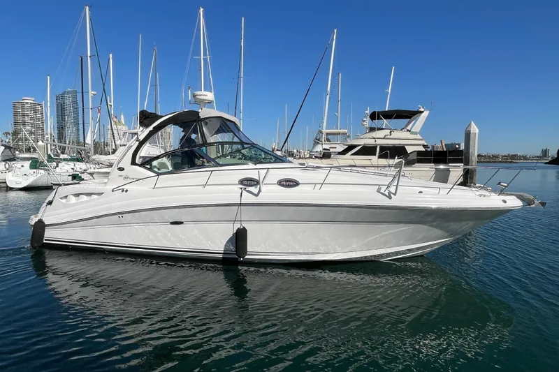 The Image of 2007 Sea Ray 340 Sundancer yacht docked in a marina under clear blue skies. - 0