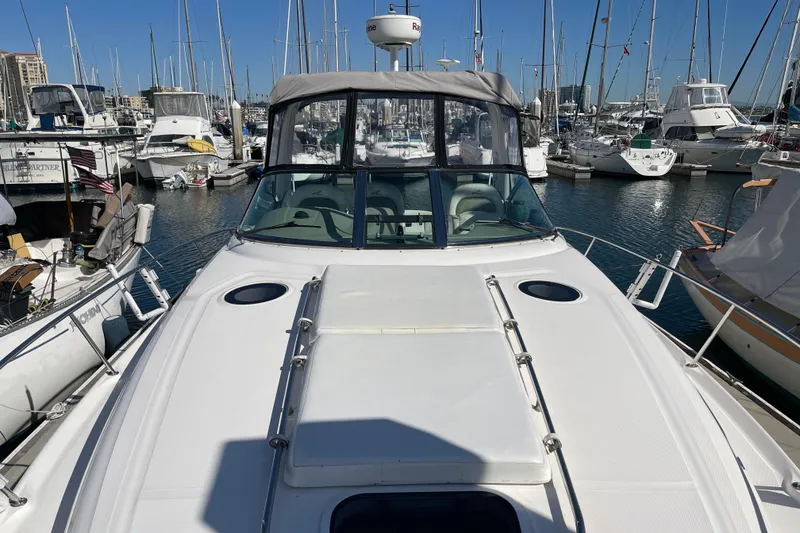 Slide: The Image of 2007 Sea Ray 340 Sundancer yacht docked in a marina, surrounded by sailboats. - 14