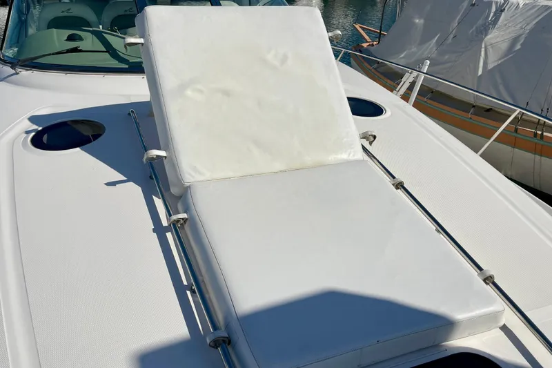 Slide: The Image of 2007 Sea Ray 340 Sundancer sunpad on deck, featuring white cushioned seating. - 16