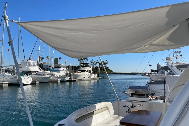Slide: The Image of 2007 Sea Ray 340 Sundancer docked in a sunny marina with sailboats. - 19
