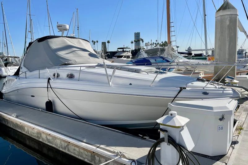 Slide: The Image of 2007 Sea Ray 340 Sundancer yacht docked at marina under clear blue sky. - 2