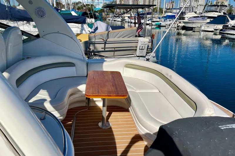 Slide: The Image of 2007 Sea Ray 340 Sundancer yacht with elegant seating and wooden table in marina. - 20