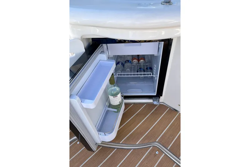 Slide: The Image of Open mini fridge on 2007 Sea Ray 340 Sundancer boat, stocked with beverages. - 24