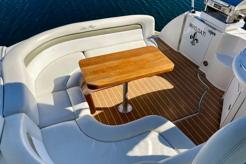 Slide: The Image of Luxurious 2007 Sea Ray 340 Sundancer boat interior with wooden table and white seating. - 25