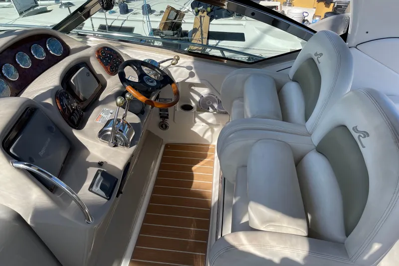 Slide: The Image of 2007 Sea Ray 340 Sundancer cockpit with dual seats, steering wheel, and control panel. - 29