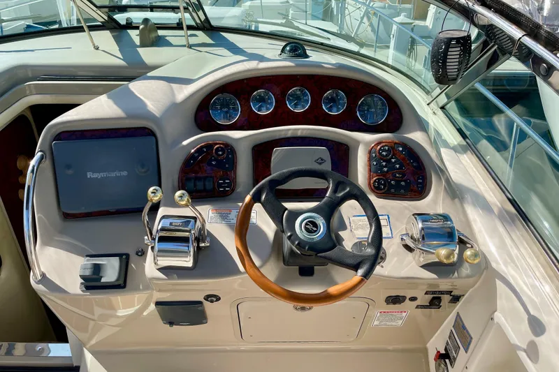 Slide: The Image of 2007 Sea Ray 340 Sundancer helm with steering wheel, gauges, and navigation equipment. - 32
