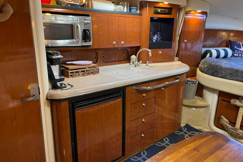 Slide: The Image of Luxurious 2007 Sea Ray 340 Sundancer yacht interior with kitchenette and cozy sleeping area. - 36