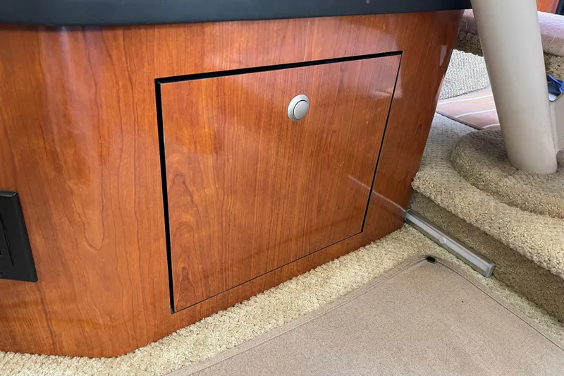 Slide: The Image of 2007 Sea Ray 340 Sundancer interior with wooden cabinet and carpeted stairs. - 42