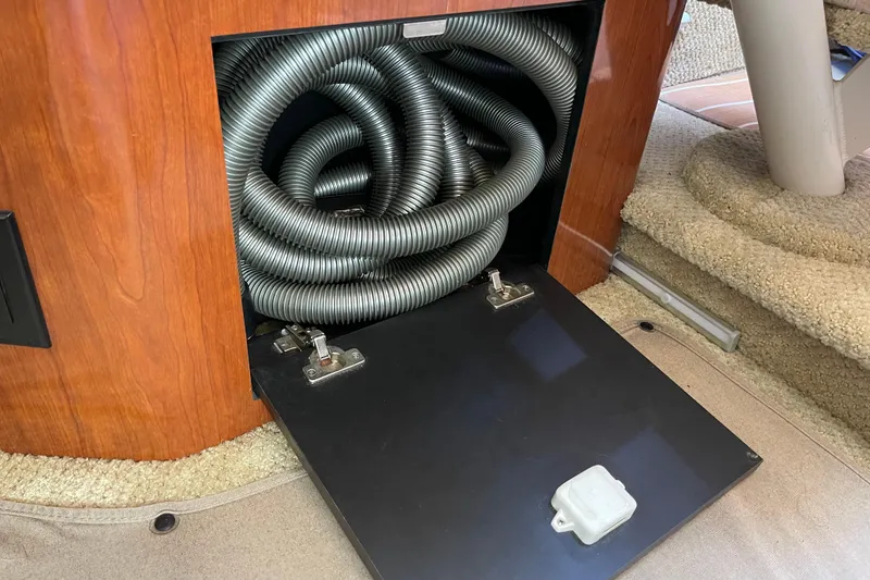 Slide: The Image of Storage compartment with coiled hoses in a 2007 Sea Ray 340 Sundancer boat. - 43