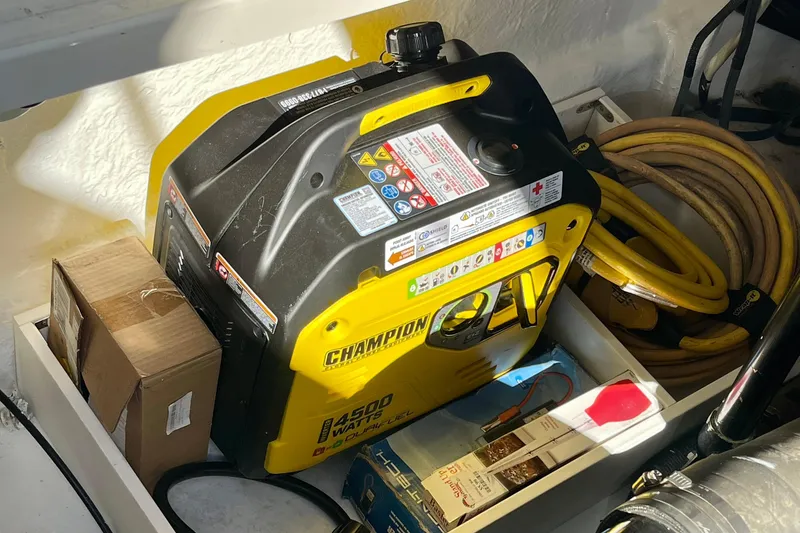 Slide: The Image of Portable Champion generator in a 2007 Sea Ray 340 Sundancer boat storage area. - 48