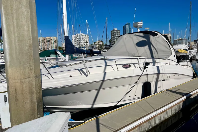 Slide: The Image of 2007 Sea Ray 340 Sundancer yacht docked at marina with city skyline background. - 5