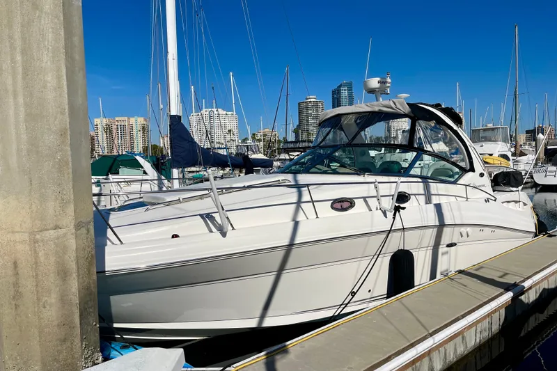 Slide: The Image of 2007 Sea Ray 340 Sundancer docked at marina with city skyline background. - 6