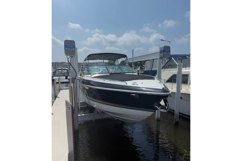 Slide: The Image of 2014 Formula 310 Bowrider boat docked at marina under clear sky. - 4