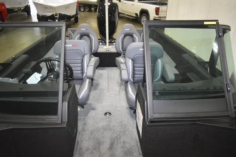 Slide: The Image of 2026 Alumacraft Competitor 185X Sport boat interior with gray seating and windshield. - 10
