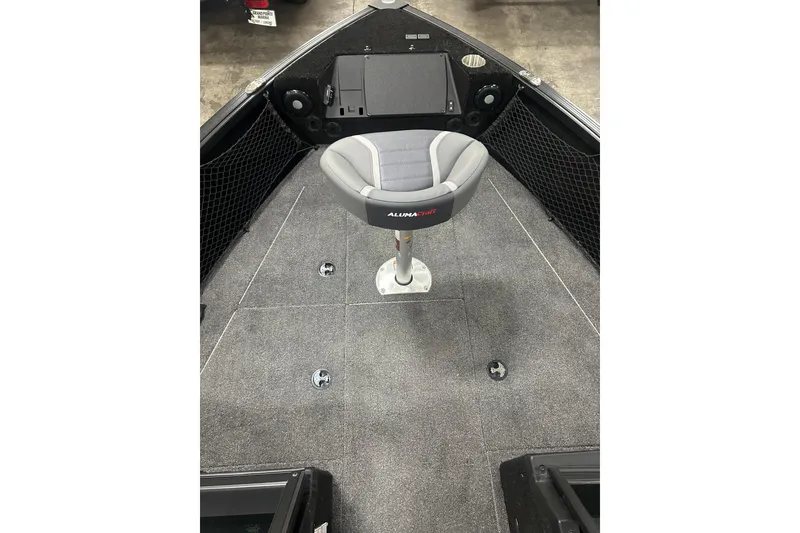 Slide: The Image of 2026 Alumacraft Competitor 185X Sport boat interior with gray seating and carpeted deck. - 14