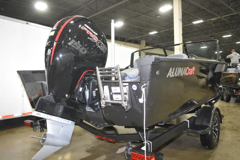 Slide: The Image of 2026 Alumacraft Competitor 185X Sport boat with Mercury 150 Pro XS engine displayed indoors. - 2