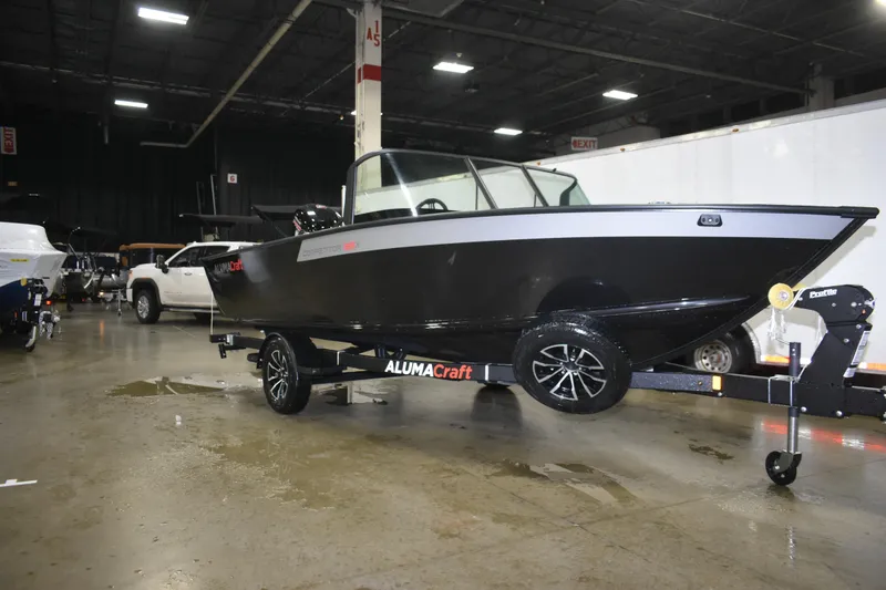 Slide: The Image of 2026 Alumacraft Competitor 185X Sport boat on display in an indoor showroom. - 4