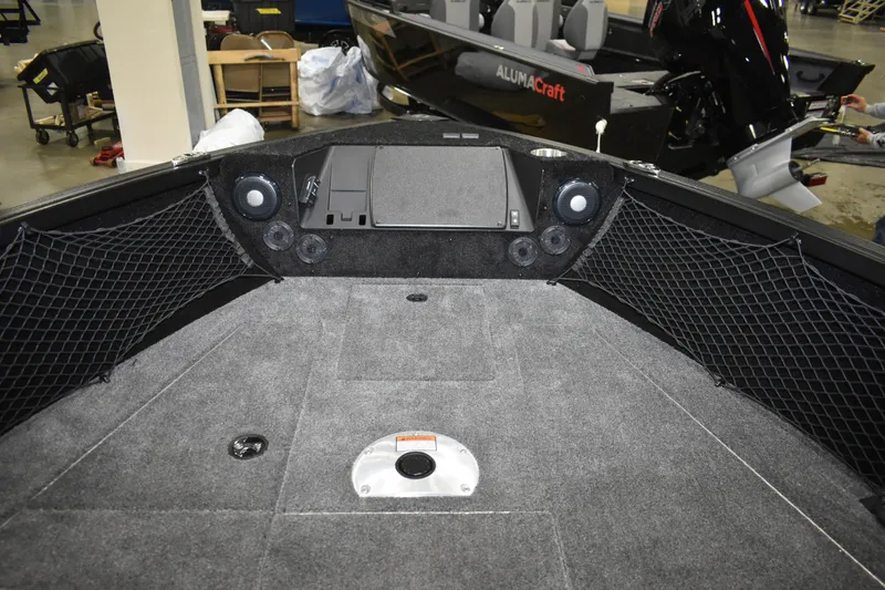 Slide: The Image of 2026 Alumacraft Competitor 185X Sport boat interior with speakers and storage nets. - 9