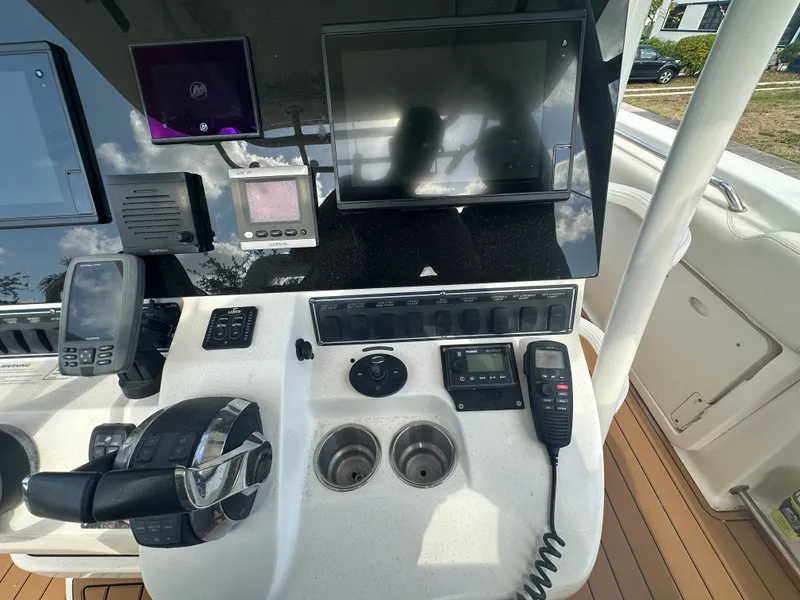 Slide: The Image of 2013 Boston Whaler 320 Outrage helm with electronics and controls. - 26